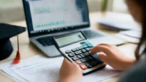 Student using loan repayment calculator with financial charts